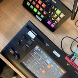 Remote controls for video production software sit on a table.