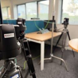 Three cameras are set up in an office space.