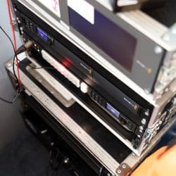 A close-up shot of professional Blackmagic Design rack-mounted video equipment housed in a silver flight case.